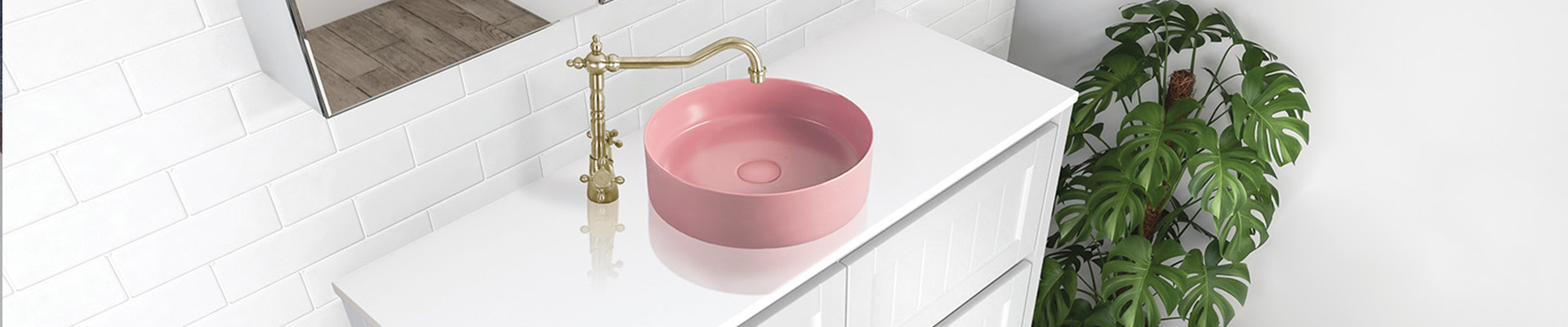 Pink top mount basin on white vanity with gold tapware