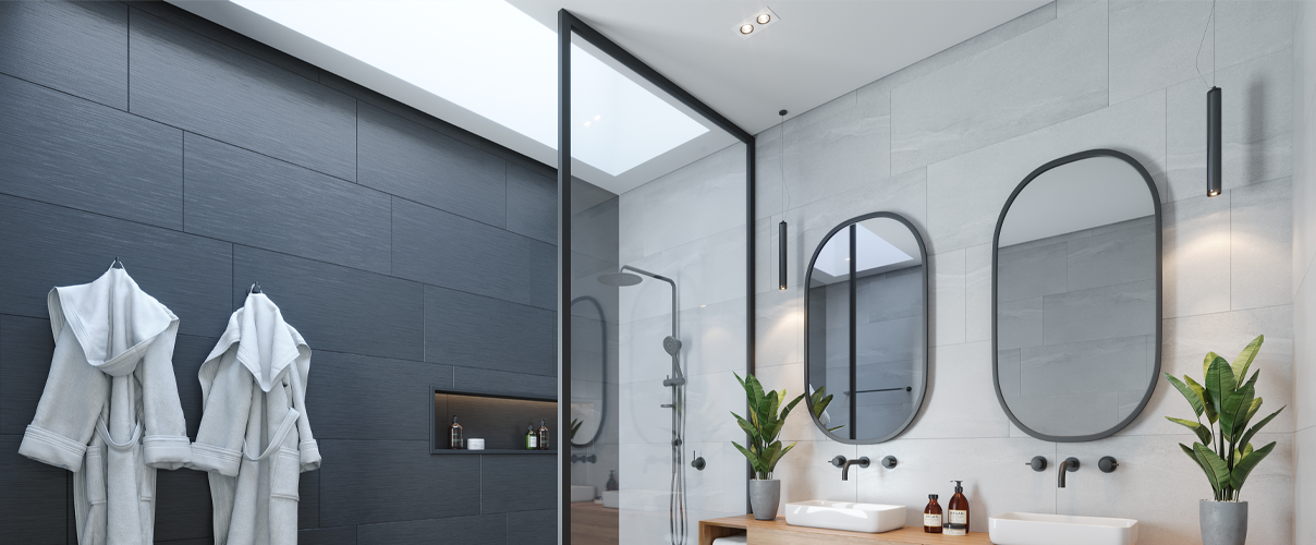 Black and white bathroom with white basins and black tapware and black shower with framed shower screen