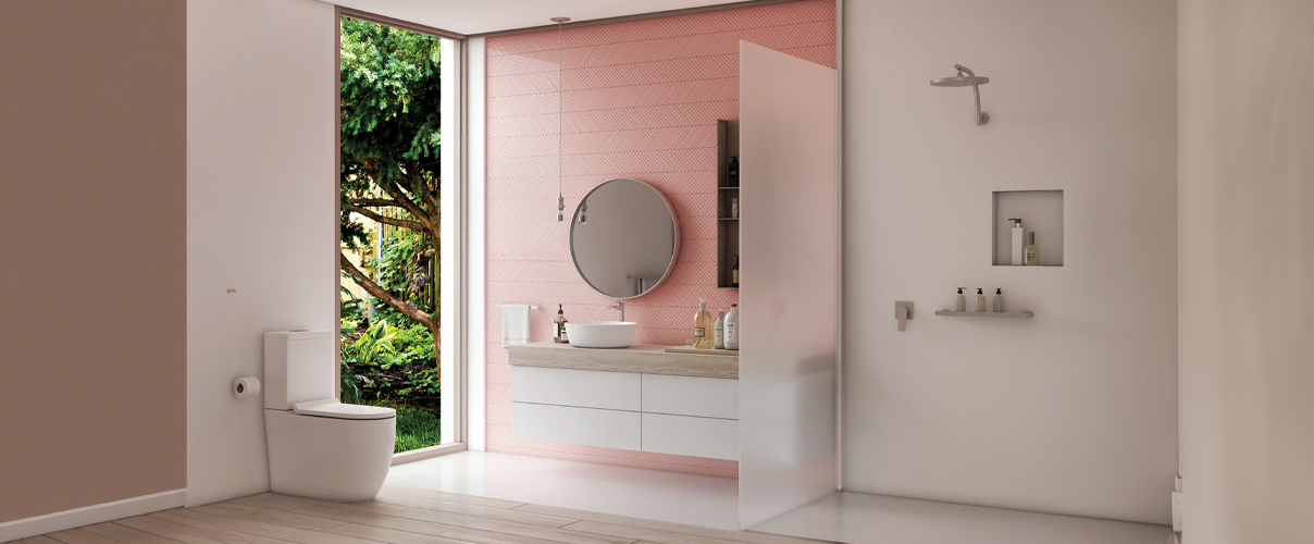 Pink coloured bathroom with frosted shower screen